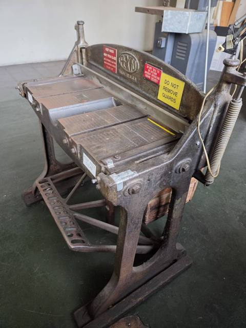 Bed, front gauge, and counterbalance spring